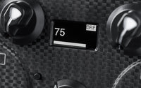 Close-up of a digital display reading 75 on a carbon fiber Fanatec CSL Load Cell Kit pedal controller.